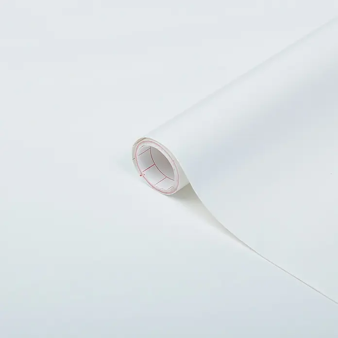 D-c-fix Klebefolie Uni Seidenmatt - 200 x 45 cm, Weiß, Selbstklebend - Nahaufnahme einer Rolle selbstklebender weißer Folie mit roten Gitternetzlinien auf der Rückseite.