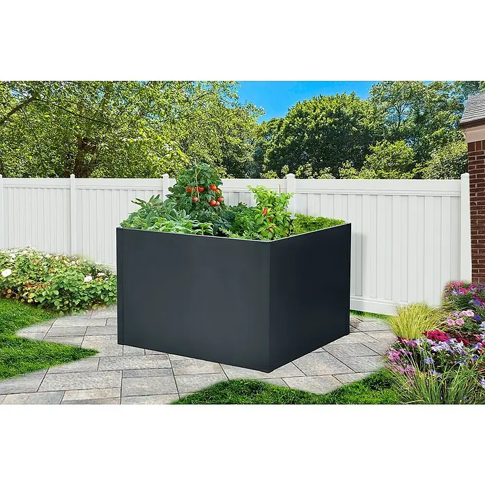Floraworld Hochbeet Twin-Wall - 90 x 90 x 76 cm, Stahl, Anthrazit - Ein hochbeetartiger Pflanzkasten aus dunkelgrauem Metall mit Gemüse und Blumen auf einer Terrasse mit einem weißen Zaun im Hintergrund.