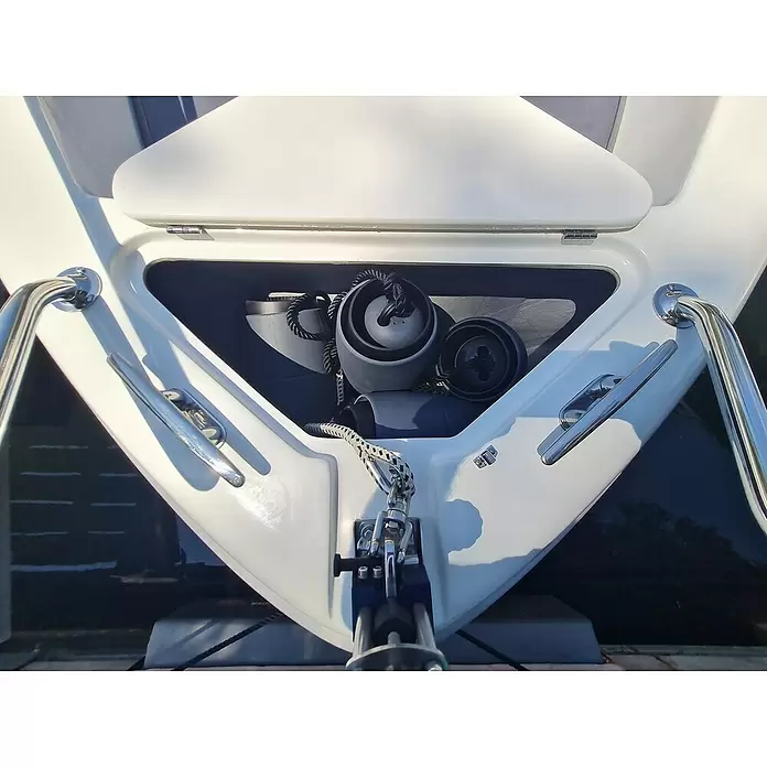Defensa multifender Zebra - Diámetro: 16,5 cm, Ajustable: 25 cm - 62 cm, Blanco/Negro - Proa de barco blanca con compartimento abierto mostrando cuerdas negras y defensas grises. Barandillas y cornamusas cromadas.
