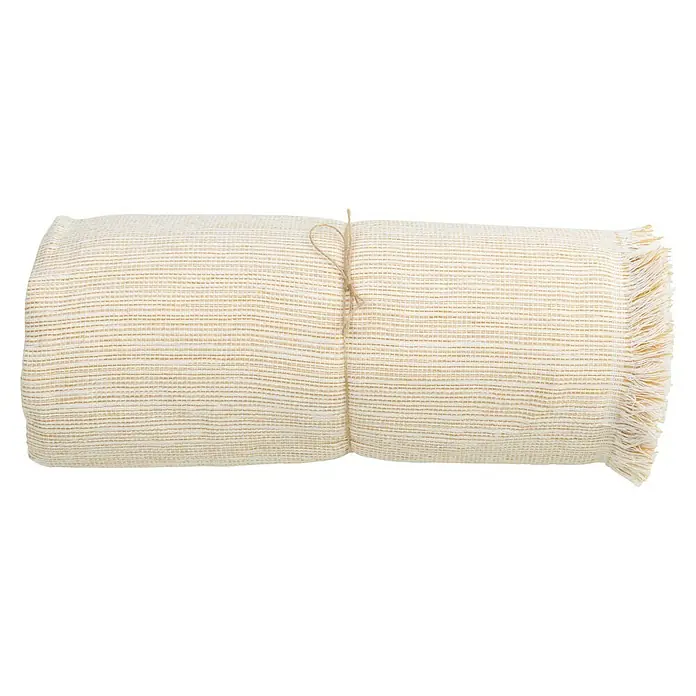 Manta para sofá Multiusos XXL - Textil, Gold - Manta enrollada color crema con flecos y sutiles rayas amarillas, atada con un cordón para un diseño elegante y práctico.