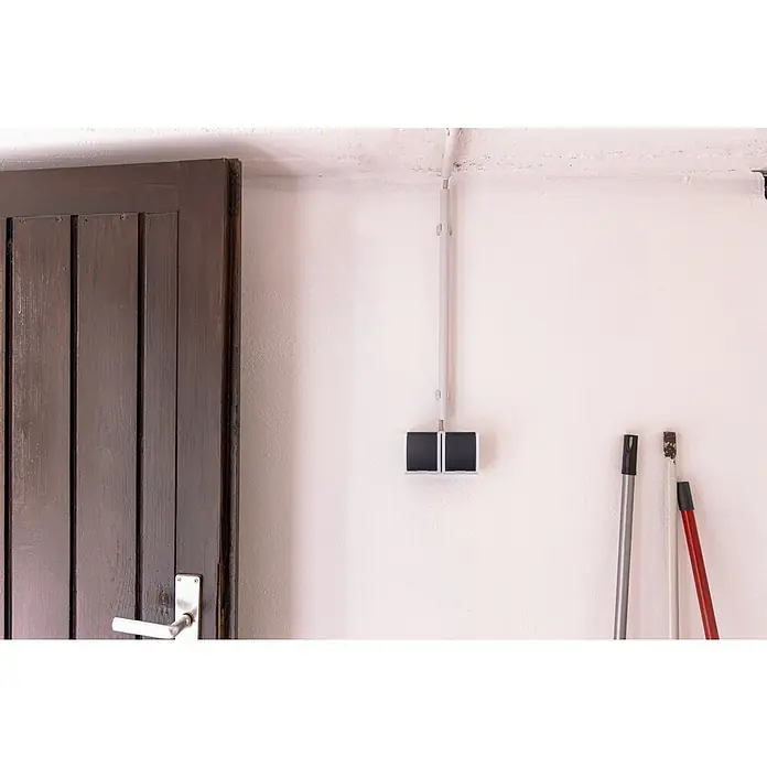 Aqua Form Feuchtraum-Steckdose - Anthrazit, 2-fach, Ausrichtung Schalterprogramm: Horizontal, Aufputzmontage, IP44 - Nahaufnahme eines Innenraums mit einer dunklen Holztür und einer elektrischen Installation an einer weißen Wand.