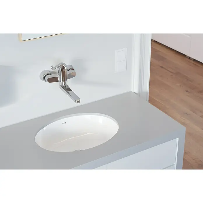 Grohe Euroeco Special Waschtischarmatur - Wandmontage, Chrom, Glänzend, Ausladung Armatur: 197 mm - Nahaufnahme eines modernen Badezimmers mit einem eleganten Waschbecken, einer stilvollen Armatur und einem schlichten Lichtschalter.