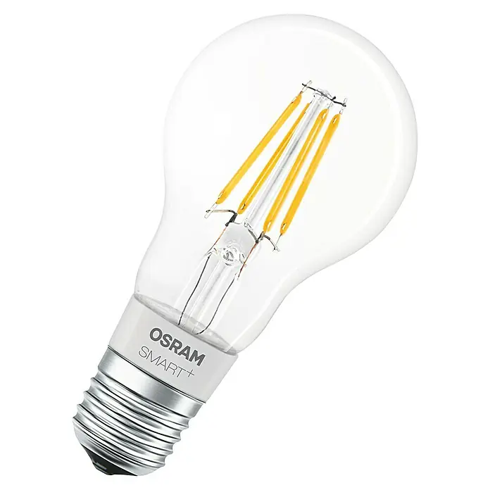 Google Nest Starter-Set Ledvance Smart+ BT Leuchtmittel - Kreide, 5,5 W, E27, Warmweiß, Dimmbar - Nahaufnahme einer OSRAM SMART+ LED-Lampe mit klarem Glaskolben und dekorativen Filamenten, die warmes Licht ausstrahlt.