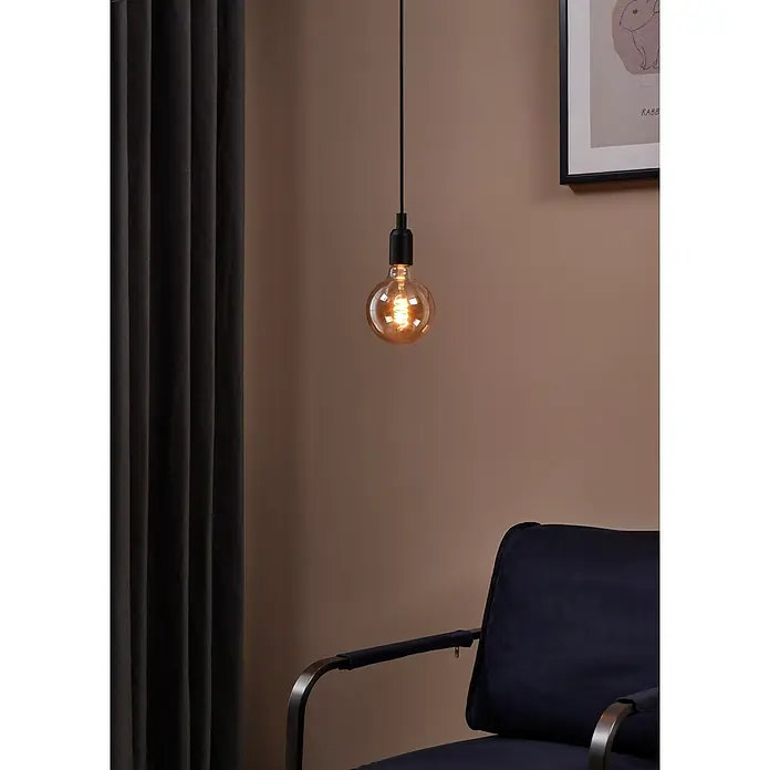 Eglo Bombilla LED Ámbar - E27, Intensidad regulable, Blanco cálido, 245 lm, 4 W - Una bombilla colgante con filamento visible, que emite una luz cálida en un espacio acogedor.