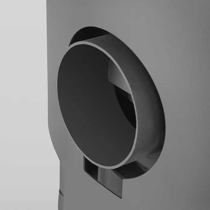 Justus Kaminofen Diego wärmePLUS - 6 kW, Raumheizvermögen: 115 m³, Material Verkleidung: Speckstein, Schwarz/Speckstein - Detailaufnahme eines modernen Ofens mit kreisförmiger Öffnung. Das Design ist minimalistisch und in Grautönen gehalten.