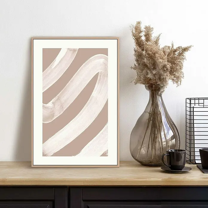 Reinders Bild Slim Frame Wood - White Curve, B x H: 20 x 30 cm - Beige und weißes abstraktes Kunstwerk im Rahmen auf einem Tisch, neben einer Vase mit Blumen und einer Tasse Kaffee.