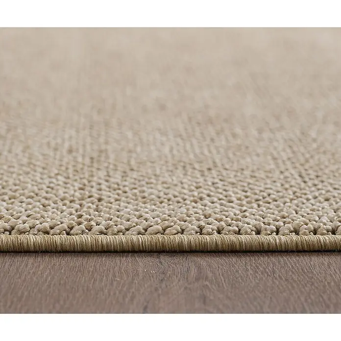 Flachgewebeteppich Loom - Beige, Durchmesser: 120 cm, 100 % Polypropylen - Nahaufnahme eines beigen Teppichs mit schlichter Bordüre auf einem Holzboden.