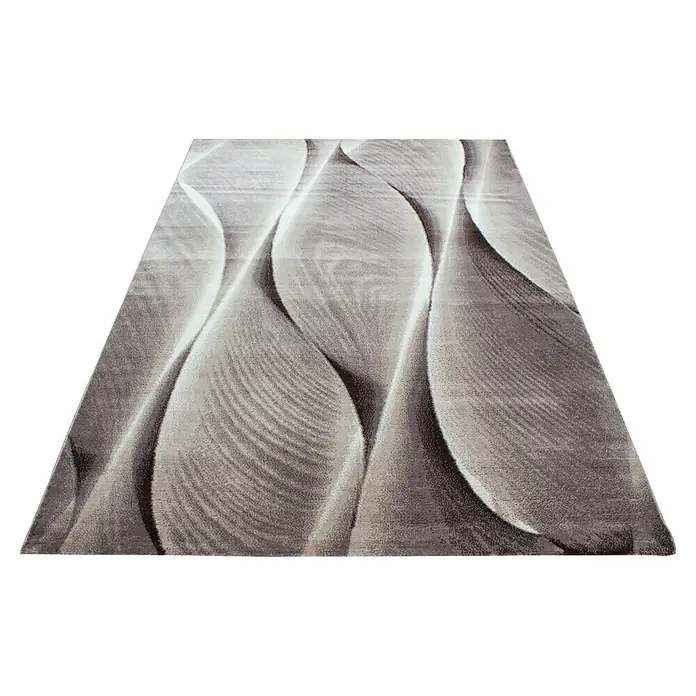Kurzflorteppich Parma 9310 - Braun, 170 x 120 cm, 100% Polypropylen - Ein grauer Teppich mit einem abstrakten Wellenmuster. Der Teppich hat eine unregelmäßige Form mit hellen und dunklen Farbtönen.