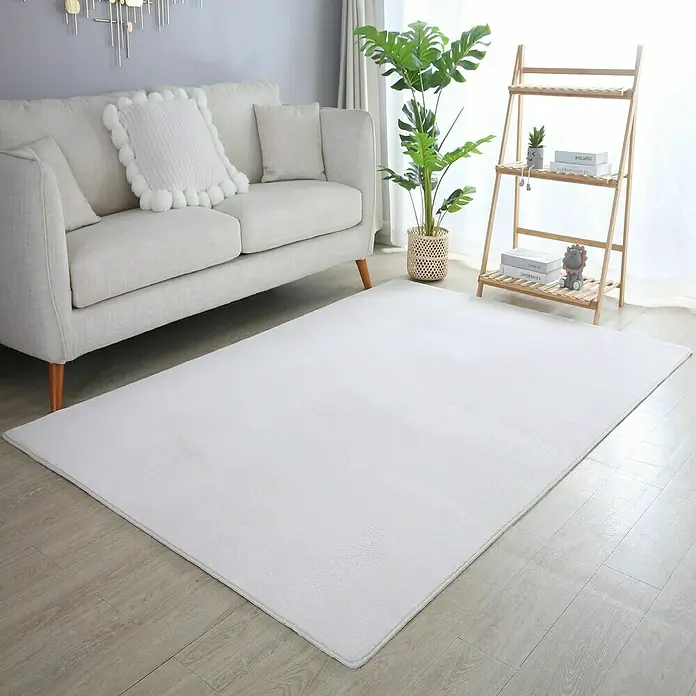 Kurzflorteppich Sky - Creme, 150 x 80 cm, 100 % Polyester - Ein weicher, weißer Teppich liegt in einem Wohnzimmer und sorgt für eine gemütliche Atmosphäre.