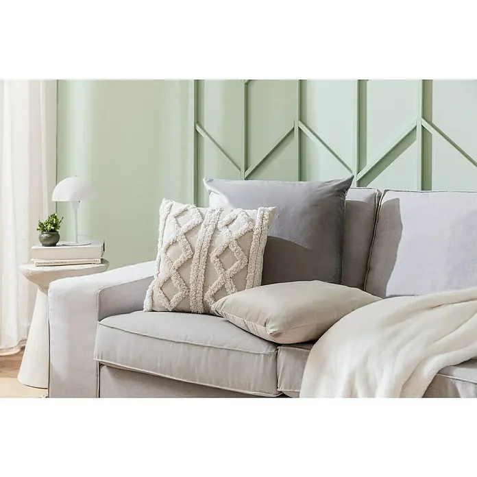 Kissen Finja - Charcoal Grey, 60 x 60 cm, 100 % Polyester - Nahaufnahme von dekorativen Kissen auf einem grauen Sofa, darunter ein cremefarbenes Kissen mit Quastenmuster.