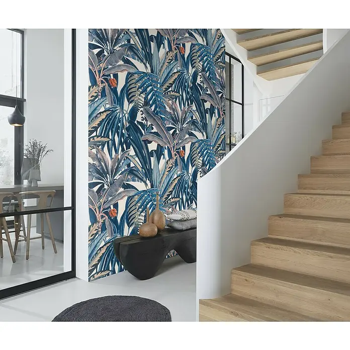 Rasch Symphony Vliestapete Blätter Dschungel - Dunkelblau, Floral, 10,05 x 0,53 m - Ein stilvoller Raum mit einer auffälligen Dschungeltapete, ergänzt durch eine moderne Treppe und ein elegantes Wohnambiente.
