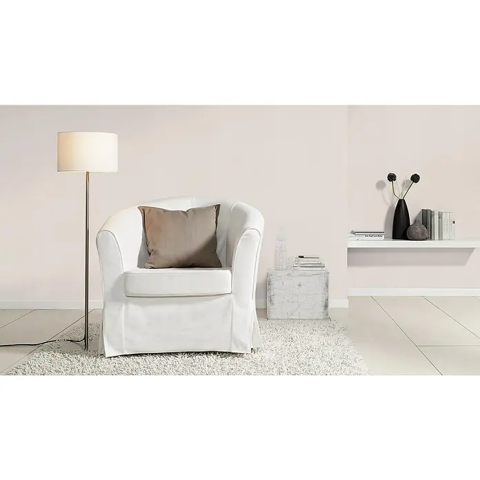 Rasch Color your life Vliestapete Struktur-Uni - Puderrosa, Uni, 10,05 x 0,53 m - Elegante weiße Sessel mit beigem Kissen, begleitet von einer Stehlampe und einem dekorativen Beistelltisch, die eine gemütliche Atmosphäre schaffen.