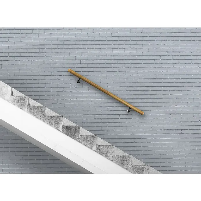 Treba Frewa Handlauf-Set H28 - Eiche, Versiegelt, Länge: 1.500 mm, Wandhalter Schwarz - Holzgeländer an einer grauen Ziegelwand neben einer Treppe. Stilvolle und sichere Treppenhausgestaltung.