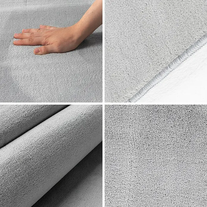 Kurzflorteppich Sky - Silber, Durchmesser: 160 cm, 100 % Polyester - Detailansicht eines grauen Badteppichs mit weicher Textur, Nahtdetails und Hand, die die Weichheit des Teppichs berührt.
