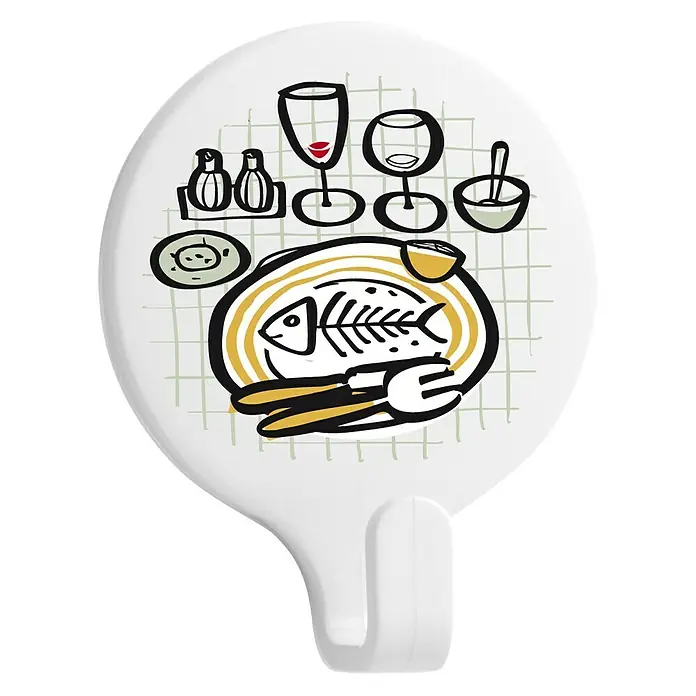 Inofix Colgador adhesivo Mesa - Blanco - Gancho de cocina con diseño de mesa de comedor. El gancho es blanco y el diseño incluye platos, copas y un pescado en un plato.