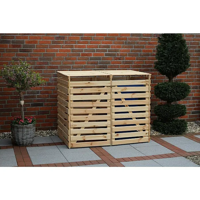 Promadino Mülltonnenbox Variov -  - Doppelter Mülltonnenbox aus Holz mit Lattenoptik und Deckel vor einer Backsteinmauer. Ein dekorativer Behälter zur Aufbewahrung von Mülltonnen.