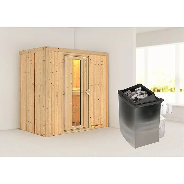 Karibu Elementsauna Nafidi - 9 kW Saunaofen mit integrierter Steuerung, L x B x H: 118 x 196 x 198 cm - Holzsauna mit Glastür und einem Saunaofen mit Steinen in einem hellen Raum.