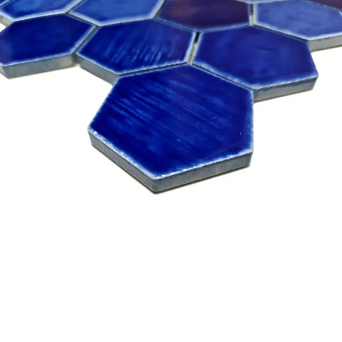 Mosaikfliese Hexagon CG SAN7 - Blau, Glänzend, L x B x S: 25,3 cm x 29,3 cm x 7 mm - Nahaufnahme von blauen Keramik-Sechseckfliesen mit glänzender Oberfläche, die ein Mosaikmuster bilden. Ideal für moderne Wand- und Bodengestaltungen.