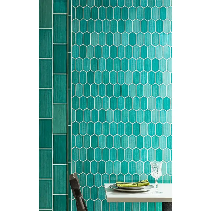 Mosaikfliese Hexagon CG CH475 - Grün, Glänzend, 25,3 cm x 29,3 cm x 75 mm - Nahaufnahme eines türkisfarbenen Wandfliesen-Designs mit länglichen Sechseck- und Ziegelformen, das eine moderne Ästhetik für Innenräume bietet.