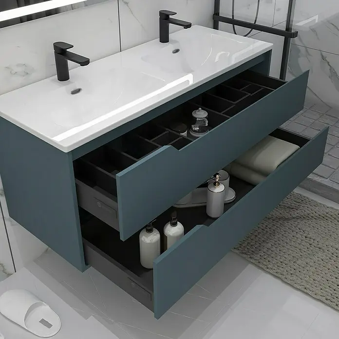 Disbain Conjunto de mueble de baño Casiopea - Ancho: 120 cm, Azul Manhattan, Mate - Un tocador de baño moderno con dos cajones en azul y una encimera blanca con dos grifos negros para un baño elegante.