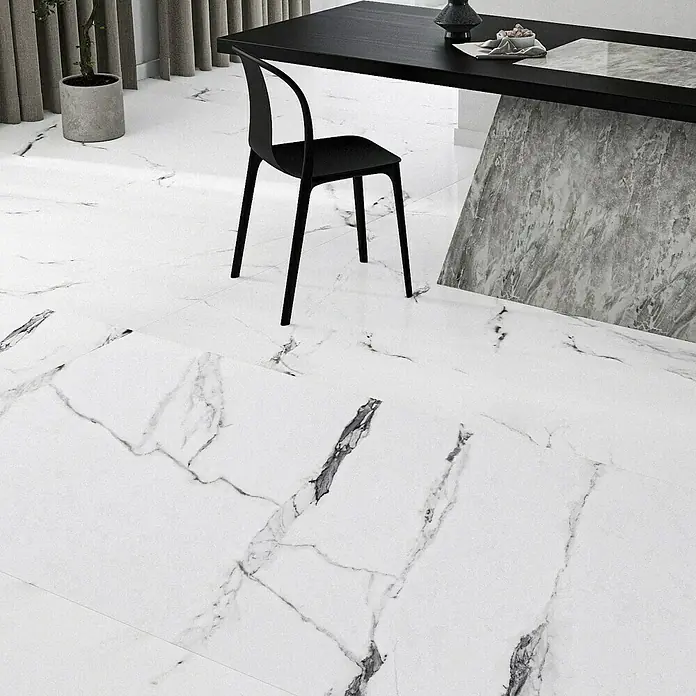 Feinsteinzeugfliese Marmi Statuario120 x 240 cm, Weiß, Glänzend - Ein Innenraum mit einem Marmorboden, einem schwarzen Tisch und einem minimalistischen Stuhl, der ein modernes, elegantes Ambiente schafft.