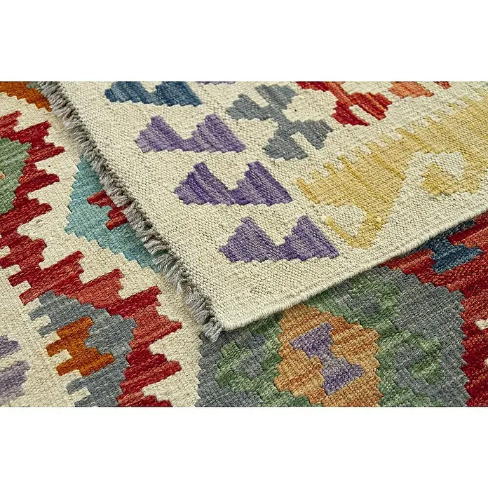 Alfombra de pelo corto Kilim Herat - Multicolor, 240 x 170 cm, 100% lana - Primer plano de una alfombra Kelim con patrones geométricos en varios colores, que muestra la artesanía tradicional.