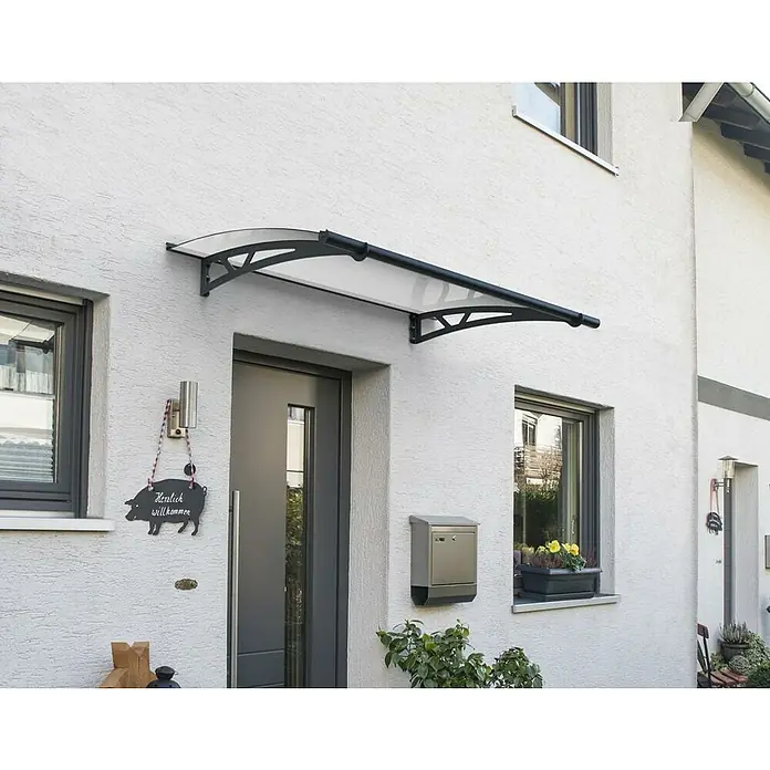 Palram – Canopia Marquesina para puerta Altair - 150,5 x 91 x 17,5 cm, Antracita - La imagen muestra un moderno toldo de puerta con un diseño claro, que proporciona protección y mejora el atractivo estético de la entrada.