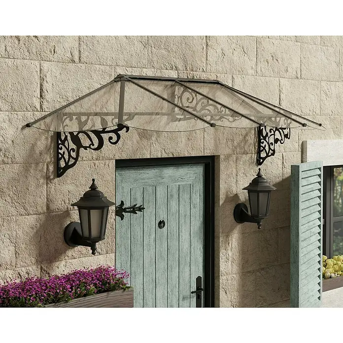 Palram – Canopia Marquesina para puerta Lily - 267 x 88 x 70 cm, Antracita - Una elegante marquesina de puerta con ornamentos de hierro forjado y dos faroles de pared al lado de la puerta.