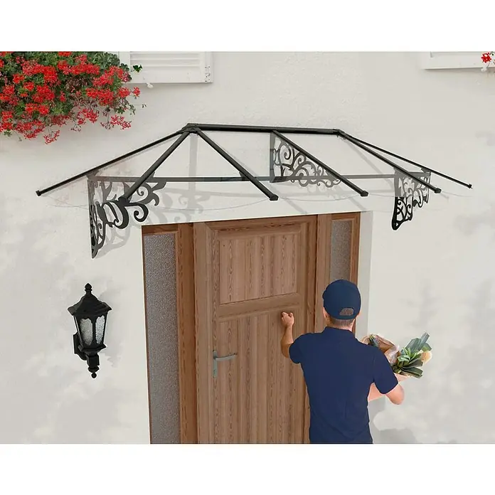 Palram – Canopia Marquesina para puerta Lily - 267 x 88 x 70 cm, Antracita - Toldo con adornos decorativos sobre una puerta principal mientras una persona llama.