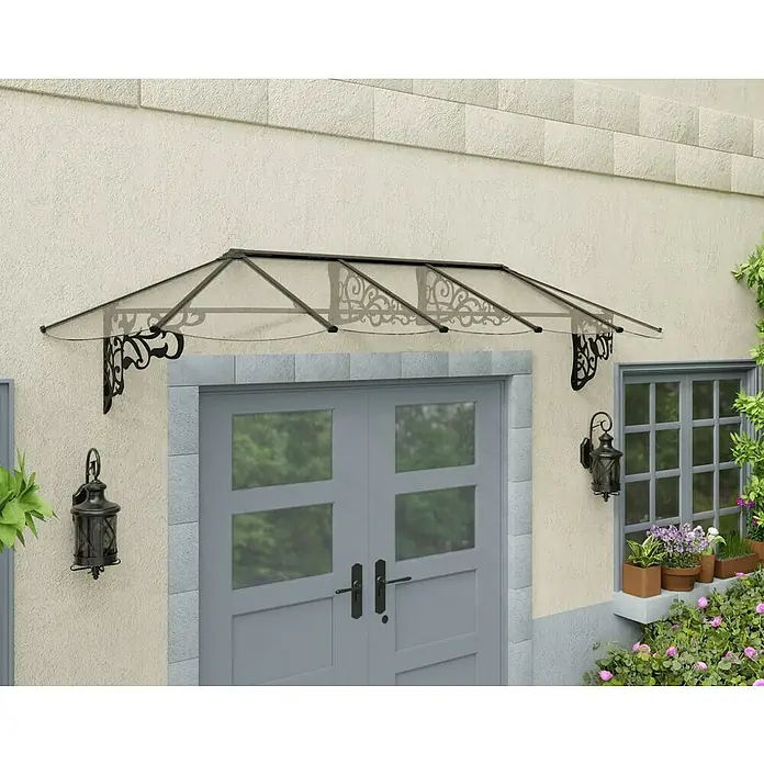 Palram – Canopia Marquesina para puerta Lily - 319 x 88 x 70 cm, Antracita - Esta imagen muestra un elegante toldo para puerta con soportes decorativos montados en el exterior de un edificio, brindando refugio.