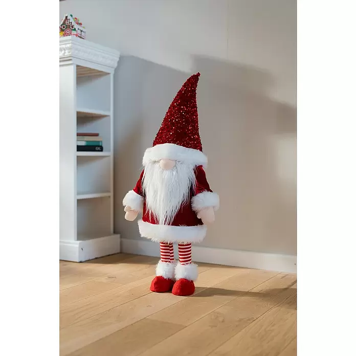 Dekofigur Weihnachtswichtel schaukelnd - L x B x H: 33 x 33 x 83 cm, Polyester - Eine stehende Weihnachtswichtel-Dekoration mit rotem Paillettenhut, langem weißen Bart, rotem Mantel, gestreiften Beinen und roten Stiefeln.