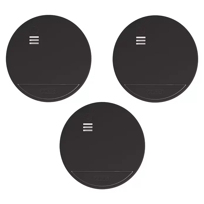 Abus Rauchwarnmelder-Set RWM90 - Alarmsignal: 85 dB, 3 Stk., Höhe: 36 mm - Drei identische dunkelgraue runde Sicherheitsgeräte mit Symbol für „kein Alarm“, drei Linien und ABUS-Logo.