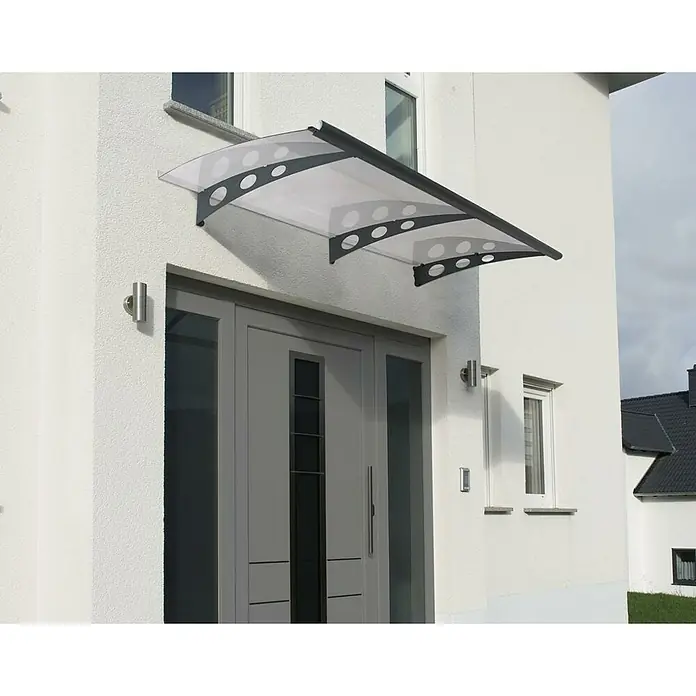 Palram – Canopia Marquesina para puerta Garamond - An x Pr x Al: 135 x 90,5 x 18,5 cm - Primer plano de un dosel moderno para puerta de entrada con techo transparente y puntales de metal oscuro con recortes redondos.