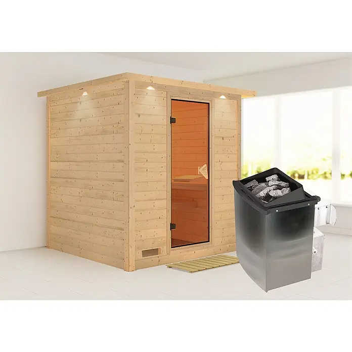 Karibu Elementsauna Mojave - Mit 9 kW Ofen mit integrierter Steuerung, Mit Dachkranz und Beleuchtung, Materialspezifizierung Tür: Ganzglas Bronze, L x B x H: 224 x 210 x 192 cm - Eine moderne Sauna mit einer Glastür und einem Saunaofen mit Steinen für ein entspannendes Saunaerlebnis.