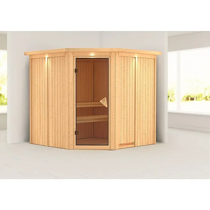 Karibu Elementsauna Jarin - Ohne Ofen, Mit Dachkranz und Beleuchtung, Materialspezifizierung Tür: Ganzglas Bronze, L x B x H: 210 x 210 x 192 cm - Eine hölzerne Ecksauna mit Glastür in einem hellen Raum. Die Sauna hat zwei Bänke im Inneren und ist mit Holz verkleidet.