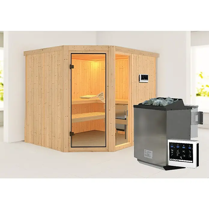 Karibu Elementsauna Fiona - Mit 9 kW Bio-Ofen mit externer Steuerung, Mit Dachkranz und Beleuchtung, L x B x H: 245 x 210 x 192 cm - Dieses Bild zeigt eine Sauna mit Ofen, die in einem Raum steht. Die Sauna ist aus hellem Holz und hat eine Glastür. Der Ofen ist aus Edelstahl.