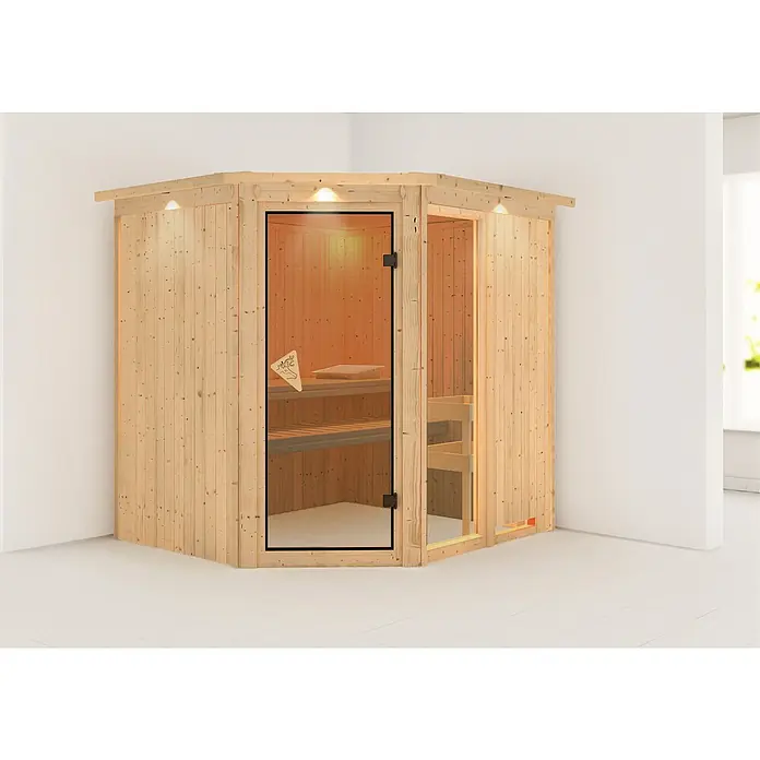 Karibu Elementsauna Fiona - Ohne Ofen, Mit Dachkranz und Beleuchtung, L x B x H: 210 x 184 x 192 cm - Eine Ecksauna aus hellem Holz mit Glastür und integrierter Beleuchtung, die eine warme und entspannende Atmosphäre verspricht.