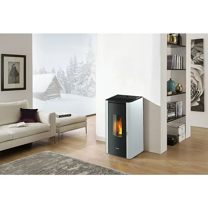 FreePoint Pelletofen Indigo - 7 kW, Raumheizvermögen: 57,6 m³ - 156 m³, Weiß - Ein moderner Pelletofen mit Flammen, der Wärme und Stil in dieses gemütliche Wohnzimmer bringt, neben Bücherregalen und bequemen Möbeln.