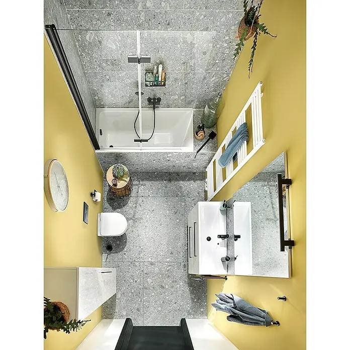 GEO Hit Pro Badewannenaufsatz B-PB400B x H: 140 x 150 cm, 2 Stk., Schwarz, DIN Anschlag: Rechts - Blick von oben auf ein modernes Badezimmer mit grauen Fliesen, gelben Wänden und weißen Sanitärobjekten.