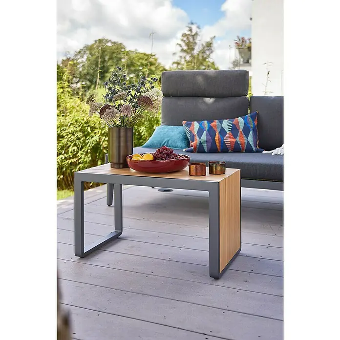 Sunfun Solo Garten-Beistelltisch - L x B x H: 77 x 41,5 x 45 cm, Aluminium, Night-Grey - Nahaufnahme eines modernen Couchtischs mit Obstschale, Vase und Kerzenhaltern auf einer Terrasse.