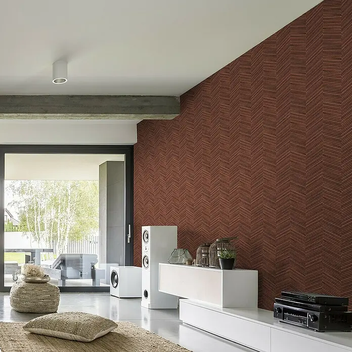 Marburg Travertino Vliestapete Fischgrätmuster - Rotbraun, Holzoptik, 10,05 x 0,53 m - Ein modernes Wohnzimmer mit einer Akzentwand in einem auffälligen Ziegelrot-Fischgrätmuster, das einen stilvollen Fokus bietet.