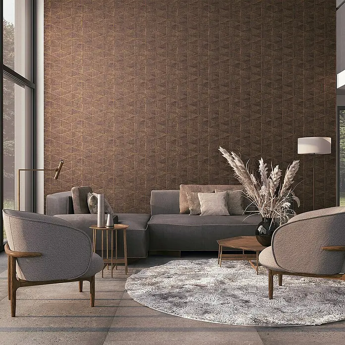 Marburg Travertino Papiertapete - Braun, Grafisch, 10,05 x 0,53 m - Wohnzimmer mit grauer Eckcouch, Sesseln und Teppich vor einer strukturierten Wand. Elegantes und modernes Design.