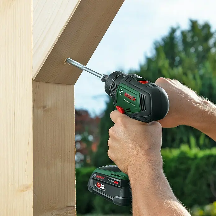 Bosch Power for All 18V Akku-Schlagbohrschrauber AdvancedImpact 18V-80 QuickSnap - 18 V, 2 Akkus, 2,5 Ah, 82 Nm - Der Bosch AdvancedDrill 18V-50 Akku-Bohrschrauber beim Eindrehen einer Schraube in ein Holzstück, ideal für Heimwerkerprojekte.