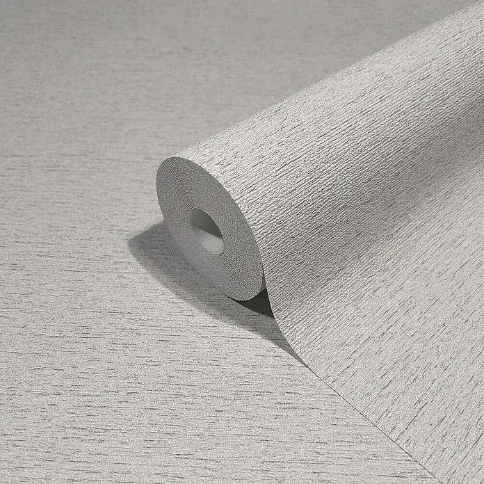 Marburg Travertino Vliestapete Struktur - Greige, Steinoptik, 10,05 x 0,53 m - Nahaufnahme einer grauen Tapetenrolle mit feiner Struktur, ideal für moderne Raumgestaltung.