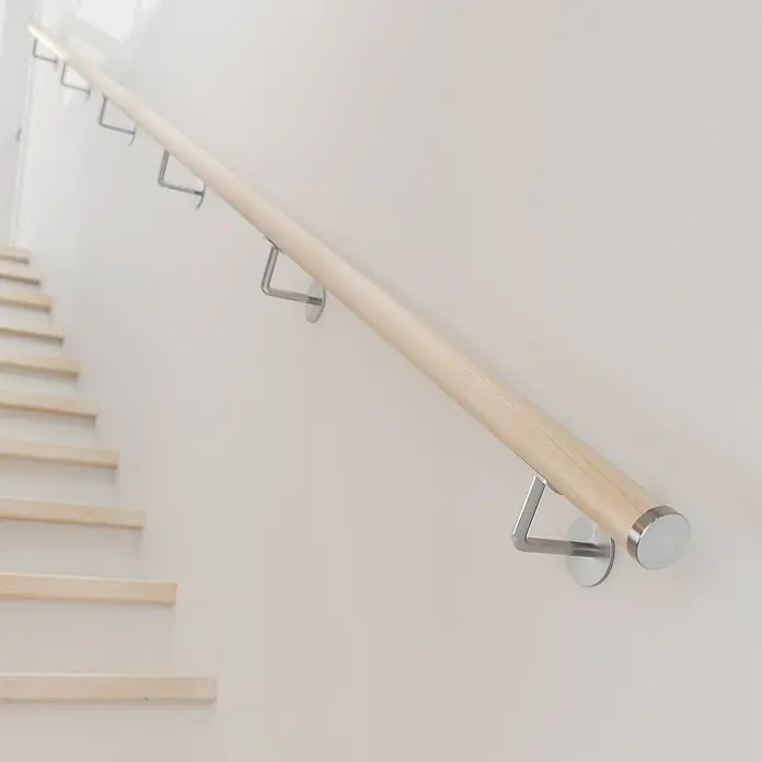 Dolle Handlauf PS 3/40 - Ahorn Natur, Lackiert, Rund, Länge: 200 cm - Helle Holztreppe mit einem schlanken, modernen Handlauf und silbernen Halterungen an einer cremefarbenen Wand.