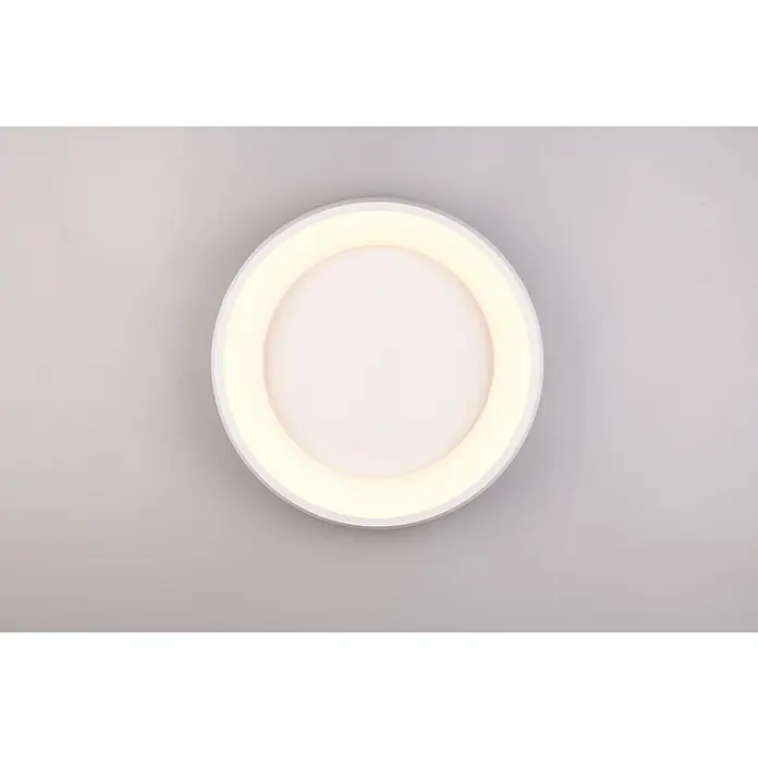 Trio Leuchten LED-Deckenleuchte rund Cardona - 29 W, Ø x H: 46,5 x 10 cm, Weiß matt, Warmweiß - Eine Nahaufnahme einer runden LED-Deckenleuchte mit einem hellen, ringförmigen Licht und einer weißen Mitte auf grauem Untergrund.