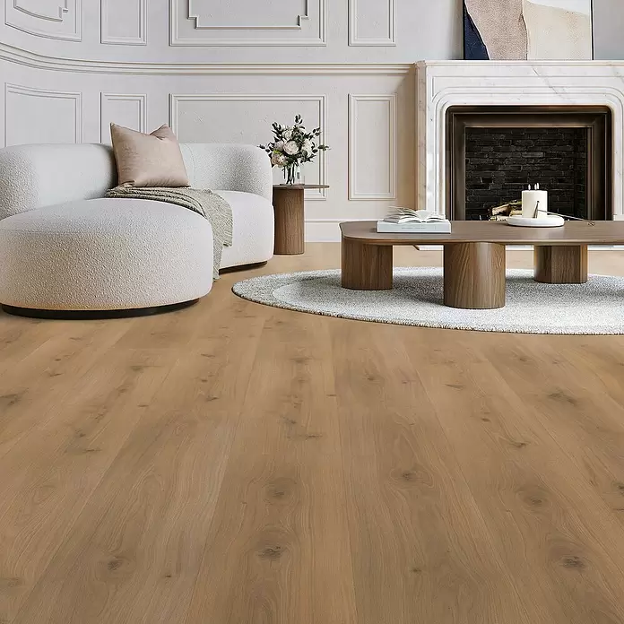 Parador Laminat Basic 600 - Eiche Horizont Natur, Landhausdiele, 1.285 x 243 x 8 mm - Helles braunes Holzparkett in einem modernen Wohnzimmer mit Sofa und Couchtisch.