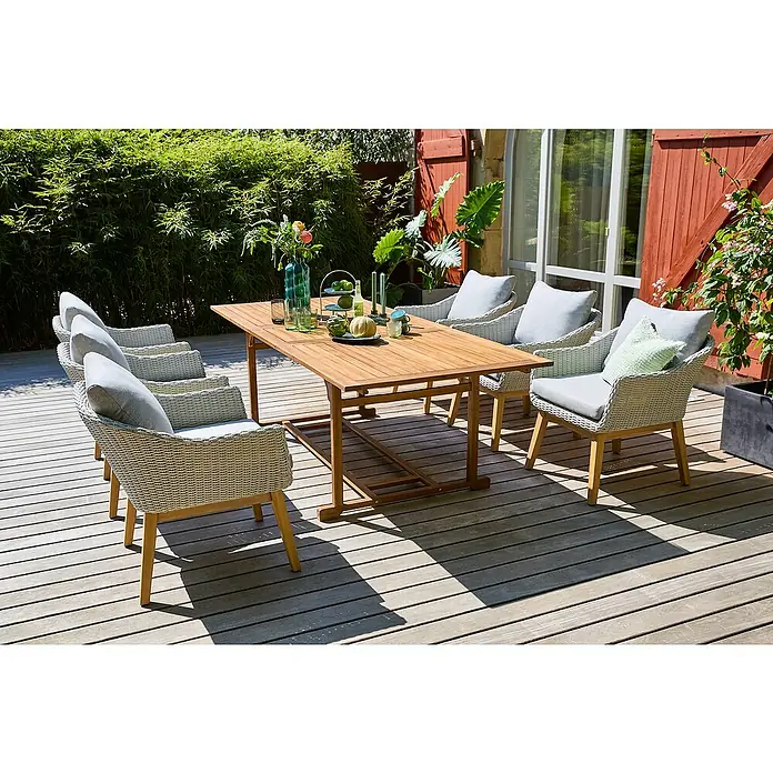 Sunfun Gartenmöbel-Set Diana/Paula XL - 7 -tlg., Hellgrau/Akazie, Ausziehbar - Eine Gartengarnitur mit einem Holztisch und Korbsesseln mit grauen Kissen auf einer Holzterrasse. Die Möbel sind elegant und wetterfest.