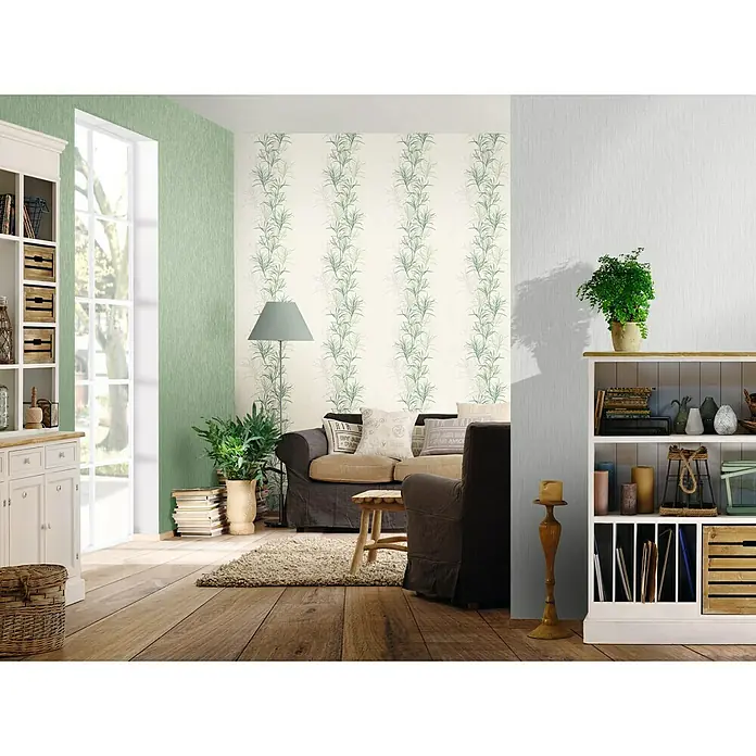 Rasch Rock'n Rolle Vliestapete Linear - Grau, Uni, 10,05 x 0,53 m - Innenaufnahme eines Wohnzimmers mit einem Sofa, einem Bücherregal und einer Stehlampe. Die Wände sind in Grün und Weiß gestrichen.