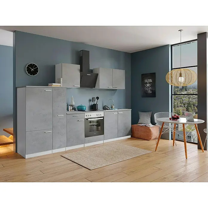 Respekta Küchenzeile Malia Typ 2 - Breite: 300 cm, Beton, Mit Elektrogeräten - Eine moderne Küche in Grau mit einer Essecke. Die Küchenschränke sind aus grauem Material mit Betonoptik gefertigt.